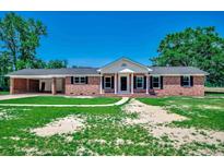 Charming brick home featuring classic black shutters, white trim, and a convenient attached carport at 4145 Highway 308, Galivants Ferry, SC 29544