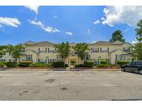 Low angle of condo exterior with yellow siding, green shutters, and handicap parking at 4430-G Montrose Ln. # G, Myrtle Beach, SC 29579