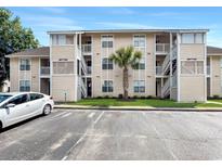 Attractive condo building with parking area, stairs to upper levels and mature landscaping at 4477 Little River Inn Ln. # 1802, Little River, SC 29566