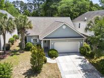 Charming single-story home featuring a two-car garage, manicured landscaping, and inviting curb appeal at 618 5Th Ave. S, North Myrtle Beach, SC 29582