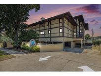 Attractive condo building with unique architecture and professional landscaping during a beautiful sunset at 6813 Porcher Dr. # 1, Myrtle Beach, SC 29572