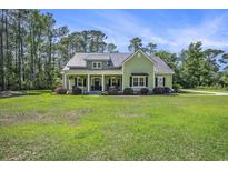 Charming one-story home with a metal roof and a large front yard at 769 Country Club Dr., Pawleys Island, SC 29585