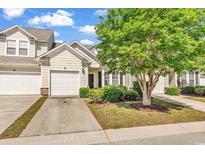 Charming exterior view features a one car garage and a beautifully landscaped yard with a mature tree providing shade at 101 Culpepper Way # 1006, Myrtle Beach, SC 29579
