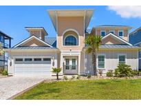 Beautiful beach home featuring a manicured lawn, garage, decorative palms and a charming front entryway at 109 Serenity Point Dr., Little River, SC 29566