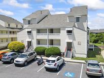 Charming condo building with balconies, parking, and accessible parking in a convenient location at 1100 Possum Trot Rd. # C-203, North Myrtle Beach, SC 29582