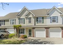 Charming townhome featuring a one car garage and landscaped front yard at 1102 Stanton Pl. # 1102, Myrtle Beach, SC 29579