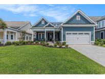 Charming two-story home with a manicured lawn, blue siding and inviting front porch at 1131 East Isle Of Palms, Myrtle Beach, SC 29579