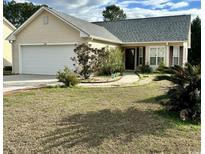 Charming single-story home with a well-manicured lawn and attached two-car garage at 118 Retreat Pl., Little River, SC 29566