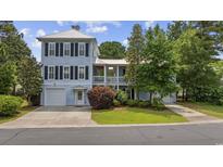 Charming two-story home with a well-manicured lawn, a garage and inviting curb appeal at 175 Summer Wind Loop, Murrells Inlet, SC 29576
