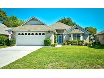 Charming single-story home featuring a manicured lawn, attached two-car garage, and well-maintained landscaping at 3105 Robyn Ct., Little River, SC 29566