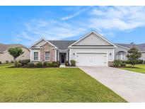 Charming single-story home with a well-manicured lawn, two-car garage, and nicely landscaped garden at 364 Palm Lakes Blvd., Little River, SC 29566