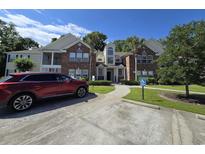 Inviting condo exterior features brick accents, manicured landscaping, and a convenient parking space at 45 Woodhaven Dr. # D, Murrells Inlet, SC 29576
