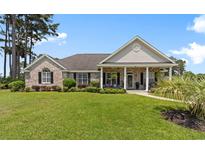 Charming brick home features a well-manicured lawn and a welcoming covered porch at 4826 Keel Ct., Myrtle Beach, SC 29579