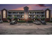 Condo building with balconies and parking in front showing dusk sky with peach and purple colors at 4853 Meadowsweet Dr. # 1805, Myrtle Beach, SC 29579