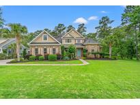 Charming home boasts a manicured lawn, lush landscaping, and a welcoming entrance at 528 Chamberlin Rd., Myrtle Beach, SC 29588
