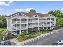 Spacious multi-level condo complex featuring charming balconies, manicured landscaping, and ample parking at 5750 Oyster Catcher Dr. # 822, North Myrtle Beach, SC 29582