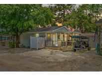Charming single-story home featuring a welcoming front porch and golf cart parking at 6001-M19 S Kings Highway, Myrtle Beach, SC 29575