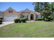 Charming single-story home featuring a well-manicured lawn and attached two-car garage at 6705 Oakmere Ct., Murrells Inlet, SC 29576