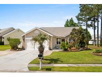 Charming single-story home featuring a well-manicured lawn, an attached two-car garage, and a cozy landscaped front yard at 675 Vermillion Dr., Little River, SC 29566