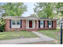 Charming brick home with a well-maintained lawn and inviting front entrance at 900 47Th Ave. N, Myrtle Beach, SC 29577