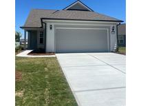 Charming single-story home featuring an attached two-car garage and a well-maintained lawn at 1248 Lady Bird Way, North Myrtle Beach, SC 29582