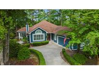 Charming blue home featuring a well manicured front yard and a winding driveway at 1325 Clipper Dr., North Myrtle Beach, SC 29582