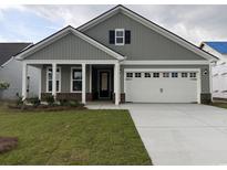 Charming single-story home with a two-car garage and well-manicured front lawn at 1436 Winding Creek Way, Myrtle Beach, SC 29588