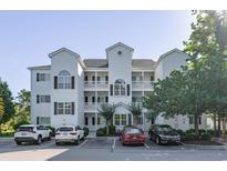 Three-story condo with white siding, black shutters, and multiple balconies at 1505 Lantern Rest Dr. # 301, Myrtle Beach, SC 29579