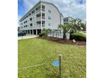 Condominium exterior showing multiple levels with balconies and a community pool area at 1509 N Waccamaw Dr. # 112, Murrells Inlet, SC 29576