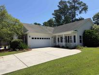 Charming single-story home with a two-car garage and beautifully landscaped front yard at 152 Rose Water Loop, Myrtle Beach, SC 29588