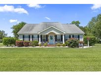 Charming home with manicured lawn, inviting front porch, and quaint welcome decor at 1609 Bridgebrook Ln., Conway, SC 29527