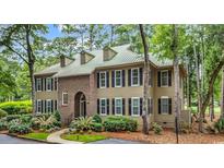 Charming two-story home boasts a lush, landscaped yard and a durable, low-maintenance metal roof at 179 Golden Bear Dr. # C4, Pawleys Island, SC 29585