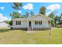 Charming single story home with a inviting front porch, black shutters, and brick foundation at 204 Elm St., Johnsonville, SC 29555