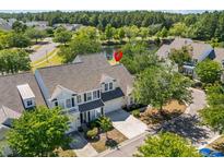 Charming home featuring a lake view, a private drive, and well-manicured landscaping at 205 Threshing Way # 1052, Myrtle Beach, SC 29579