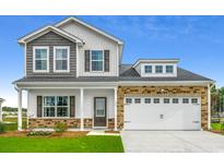 Charming two-story home with a mix of stone and siding, complemented by a well-manicured lawn at 311 Dunlin Pl, Conway, SC 29526