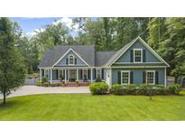 Charming home featuring blue siding, black shutters, and a well-manicured lawn at 3180 Long Avenue Ext., Conway, SC 29526