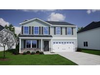 Two-story home features a two-car garage, stone accents, and a manicured lawn at 335 Garden Grove St, Conway, SC 29526