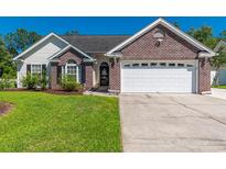 Charming single-story home with a well-manicured lawn, brick accents, and an attached two-car garage at 359 Harbour Reef Dr., Myrtle Beach, SC 29588