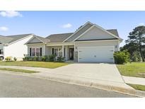 Charming single-story home with a well-manicured lawn and a two-car garage, offering great curb appeal at 417 Grain Field Dr., Georgetown, SC 29440