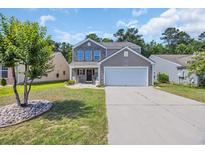 Charming two-story home featuring a two-car garage, and a beautifully landscaped front yard at 4501 Farm Lake Dr., Myrtle Beach, SC 29579
