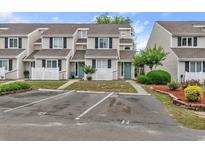 Charming townhome featuring a manicured lawn, dedicated parking, and inviting curb appeal in a friendly community at 600 Deer Creek Rd. # D, Surfside Beach, SC 29575