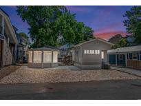 Charming home featuring a gazebo, gray siding, rock landscaping, and well-lit exterior for evening appeal at 6001 - 1842 S Kings Hwy., Myrtle Beach, SC 29575