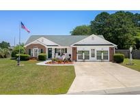 Charming home featuring a beautifully landscaped front yard, inviting entryway and brick accents at 601 Jousting Ct., Conway, SC 29526