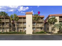 Three story beach condo featuring multiple balconies, lush landscaping, and ample parking at 6309 N Ocean Blvd. # 14 E, North Myrtle Beach, SC 29582