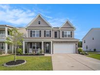 Charming two-story home with gray siding, black shutters, and a well-manicured front lawn at 8076 Fort Hill Way, Myrtle Beach, SC 29579