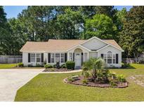 Charming single-story home with manicured front yard, a beautiful garden and a welcoming entrance at 990 Chateau Dr., Conway, SC 29526