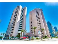 Condominium exterior featuring two high-rise buildings, palm trees, parking, and clear blue skies at 2500 N Ocean Blvd. # 102, Myrtle Beach, SC 29577