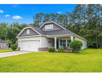 Charming single-story home with a manicured lawn, covered porch, and attached garage, ideal for suburban living at 260 Dunbarton Ln., Conway, SC 29526