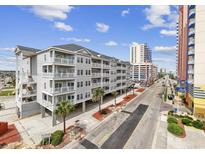 Beautiful exterior view of a condo building with balconies and street view at 3401 N Ocean Blvd. # 110, North Myrtle Beach, SC 29582