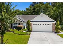 Charming single-story home with manicured lawn, brick facade, and two-car garage at 4 Clemson Rd., Conway, SC 29526